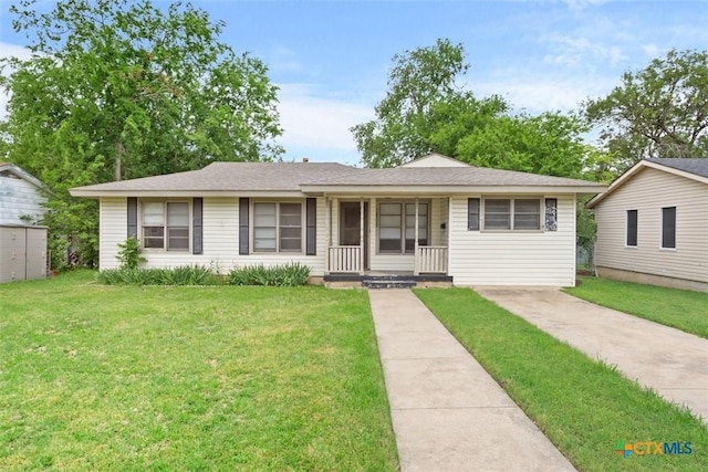 ranch-style house with a porch and a front yard
