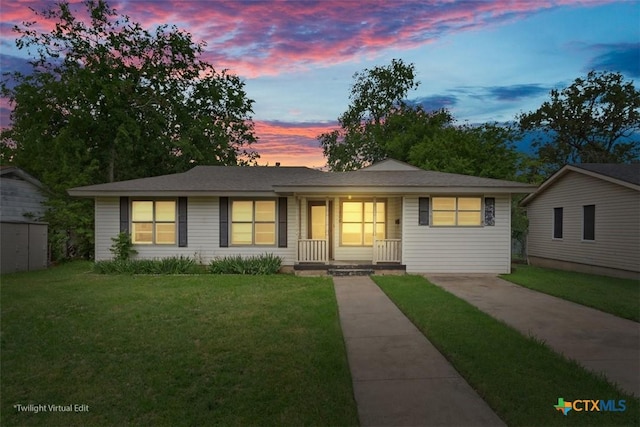 ranch-style home featuring a porch and a front lawn