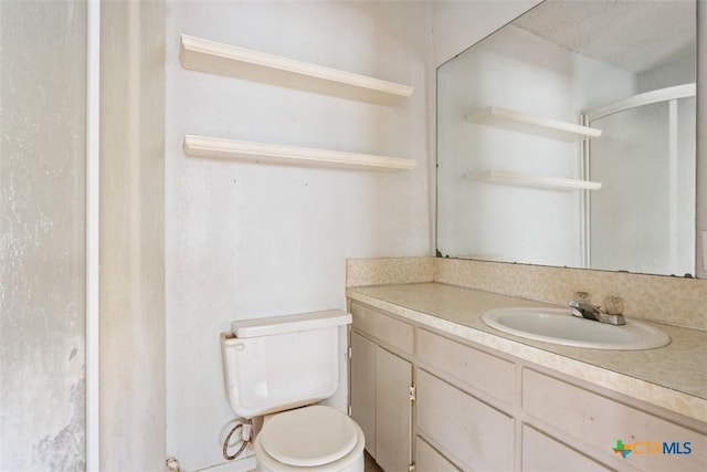 full bath with vanity, a shower with shower door, and toilet
