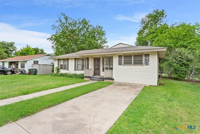 ranch-style home with covered porch, driveway, and a front lawn