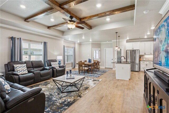 2085 Mercer St, Nolanville, TX 76559 - living area featuring light wood finished floors, ceiling fan, beam ceiling, recessed lighting, and ornamental molding