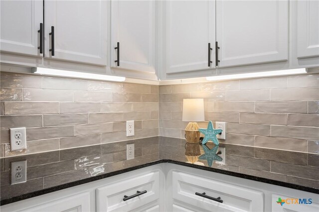 2085 Mercer St, Nolanville, TX 76559 - kitchen with decorative backsplash, white cabinets, and dark stone counters