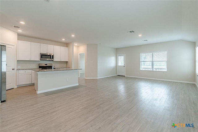 2824 Green Finch, New Braunfels, TX 78130 - kitchen featuring stainless steel appliances, open floor plan, light wood-style floors, white cabinets, and recessed lighting