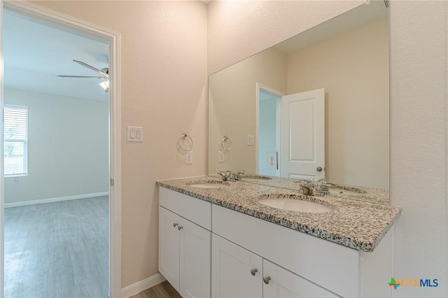 2824 Green Finch, New Braunfels, TX 78130 - full bath featuring double vanity, wood finished floors, a ceiling fan, and baseboards