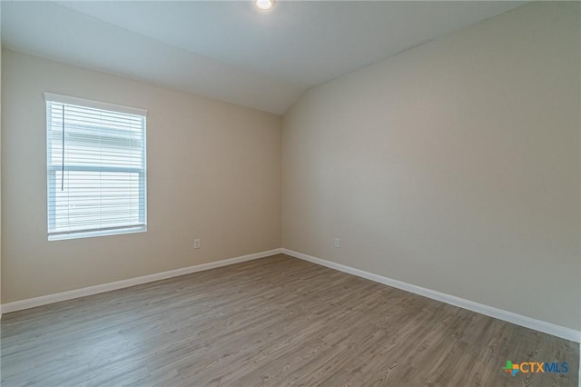 2824 Green Finch, New Braunfels, TX 78130 - empty room with wood finished floors, baseboards, and vaulted ceiling