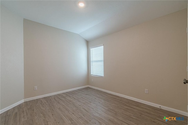 2824 Green Finch, New Braunfels, TX 78130 - unfurnished room featuring wood finished floors, vaulted ceiling, and baseboards