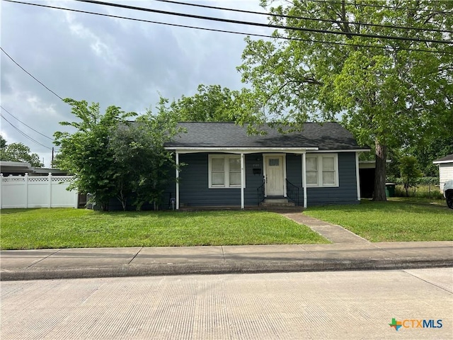view of front of property featuring a front lawn, fence, and entry steps