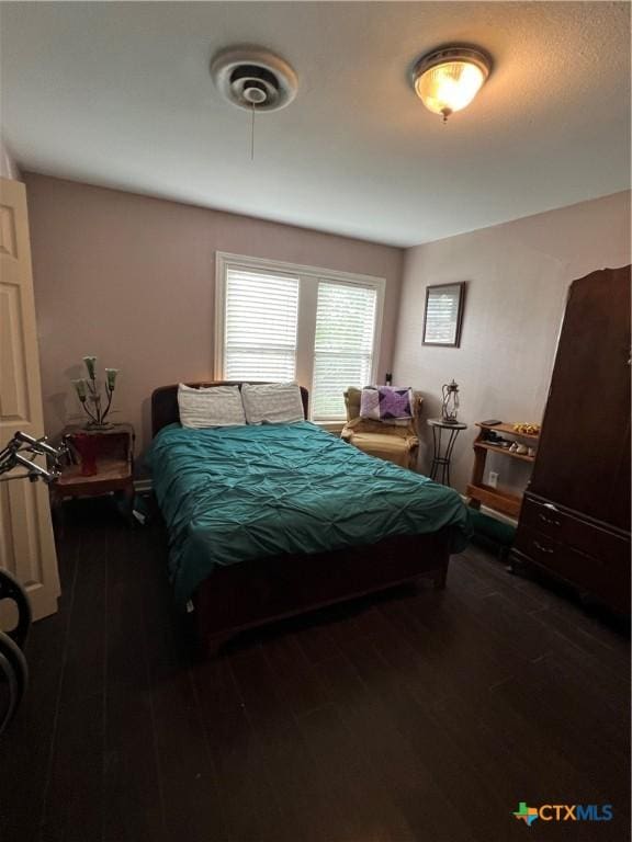 bedroom with wood finished floors