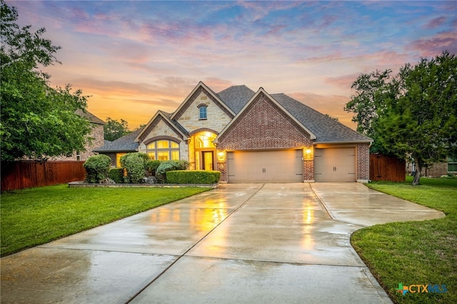 959 Wilderness Trl, New Braunfels, TX 78132 - french provincial home featuring an attached garage, driveway, brick siding, and stone siding