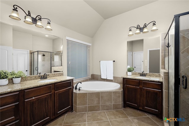 959 Wilderness Trl, New Braunfels, TX 78132 - full bath with a stall shower, a garden tub, tile patterned floors, two vanities, and vaulted ceiling