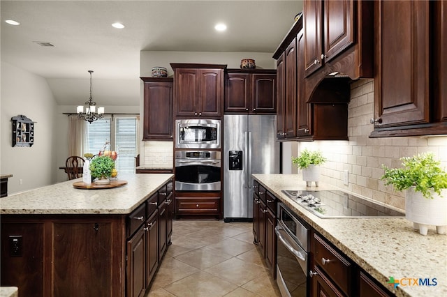 959 Wilderness Trl, New Braunfels, TX 78132 - kitchen with stainless steel appliances, decorative backsplash, a chandelier, pendant lighting, and dark brown cabinetry