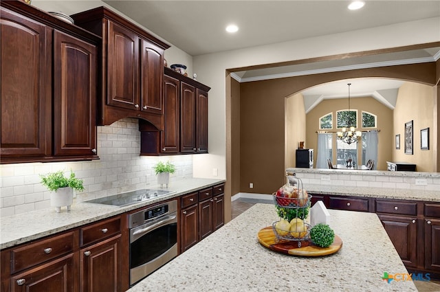 959 Wilderness Trl, New Braunfels, TX 78132 - kitchen featuring oven, black electric cooktop, a chandelier, backsplash, and vaulted ceiling