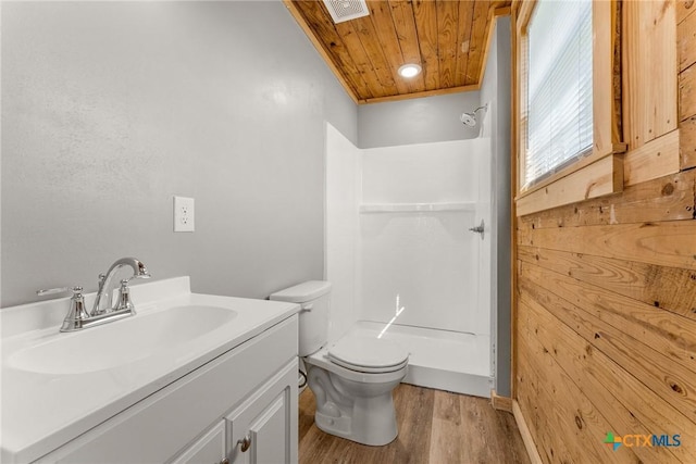 bathroom with hardwood / wood-style flooring, walk in shower, wooden ceiling, and vanity