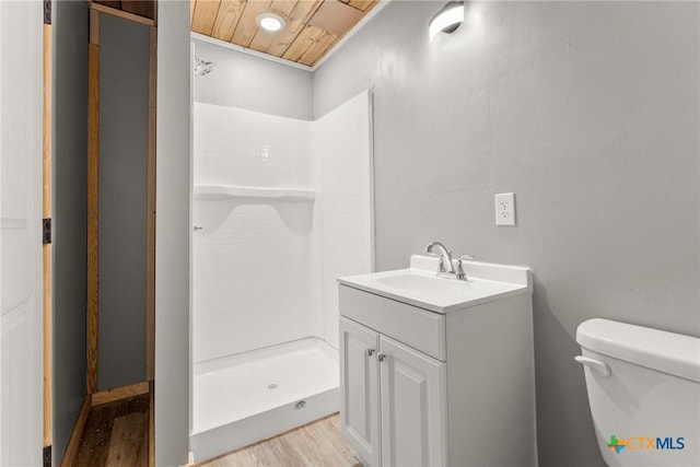 bathroom with toilet, walk in shower, wood ceiling, wood-type flooring, and vanity