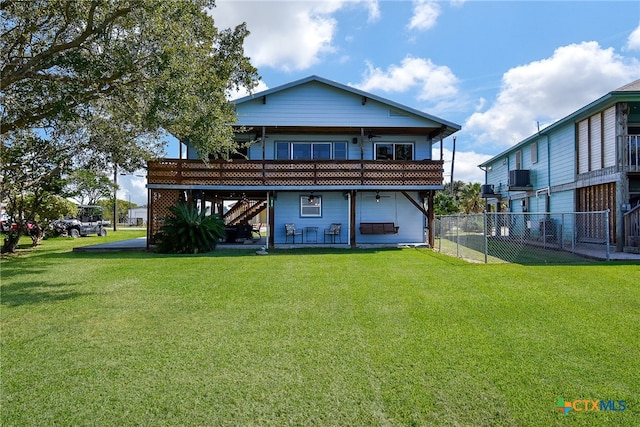 back of house with a balcony, a patio, and a yard