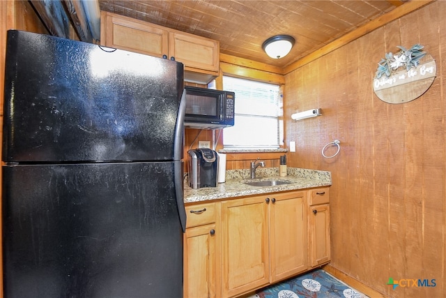 kitchen featuring wood ceiling, sink, black appliances, and wooden walls