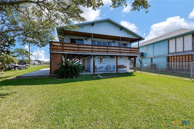 rear view of house featuring a yard