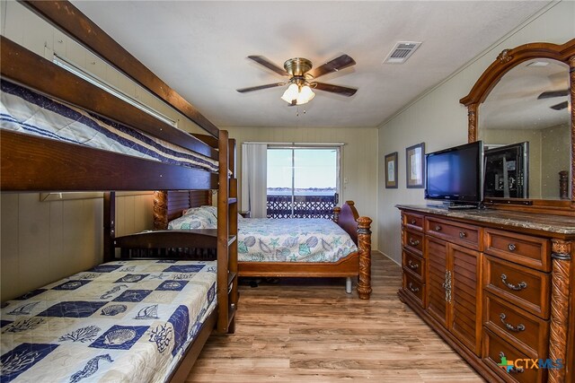 bedroom featuring ceiling fan, light hardwood / wood-style flooring, and access to outside