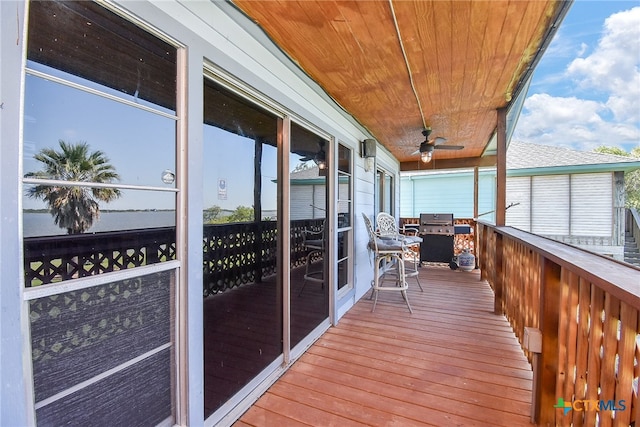 wooden balcony featuring ceiling fan and a wooden deck