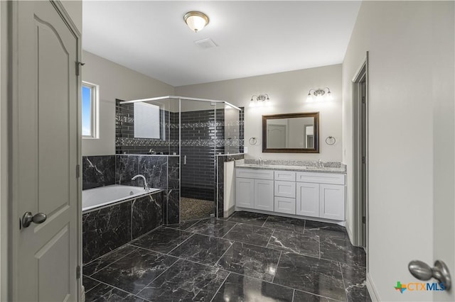 bathroom featuring vanity and shower with separate bathtub