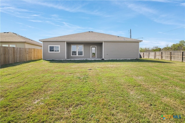 back of property featuring a lawn