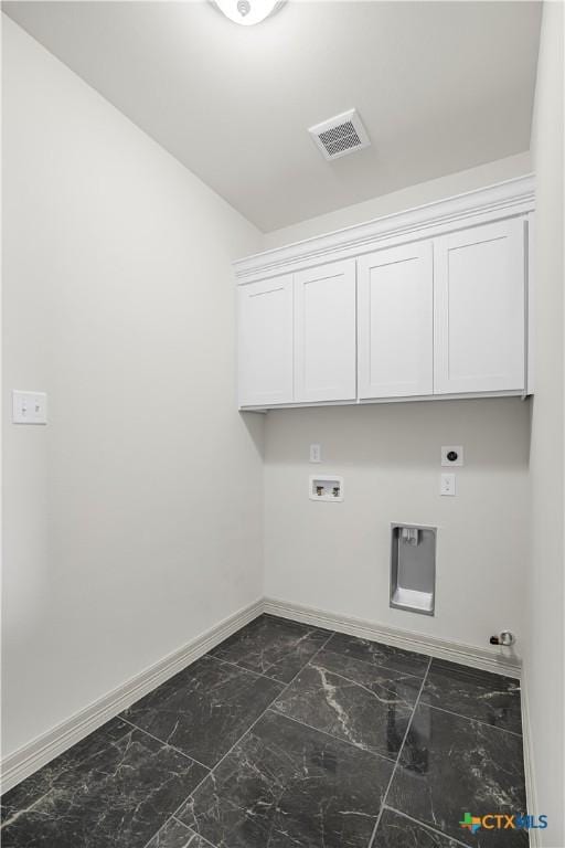 clothes washing area with washer hookup, electric dryer hookup, and cabinets