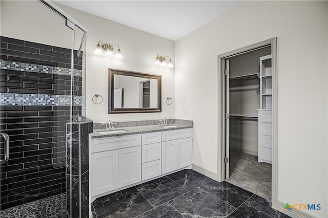 bathroom with vanity and a shower with shower door