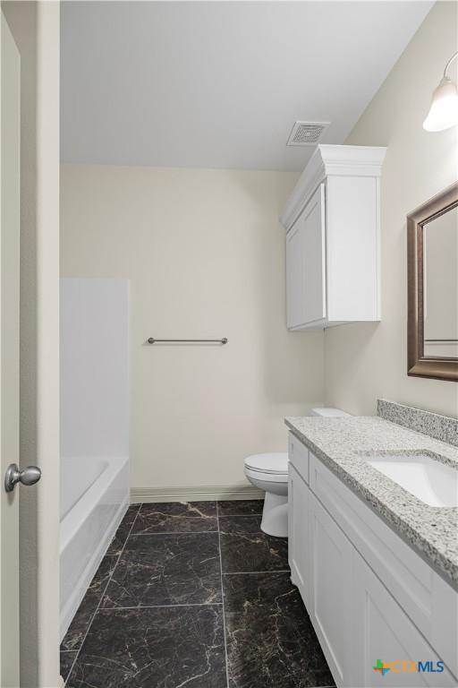 bathroom featuring vanity and toilet