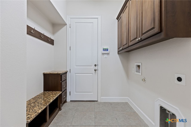3437 De Soto Loop, Round Rock, TX 78665 - laundry area with electric dryer hookup, cabinet space, washer hookup, light tile patterned flooring, and baseboards
