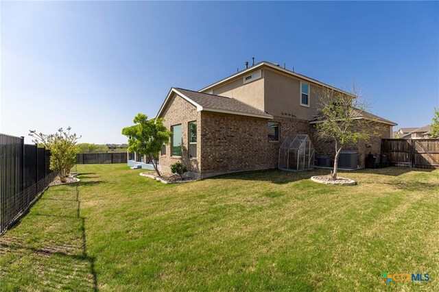 3437 De Soto Loop, Round Rock, TX 78665 - rear view of property with brick siding and central AC unit
