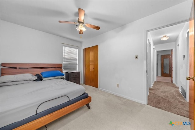 bedroom featuring ceiling fan and light colored carpet