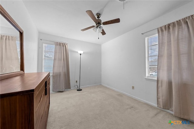 empty room with ceiling fan and light colored carpet