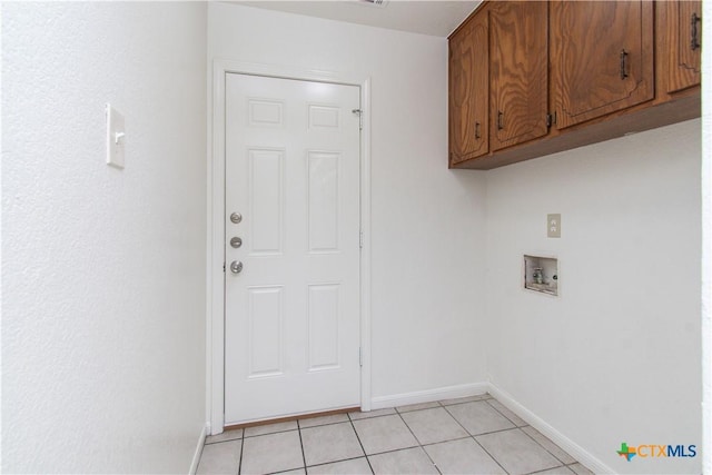2009 Fleetwood Dr, Killeen, TX 76543 - laundry room with cabinet space, washer hookup, and light tile patterned floors