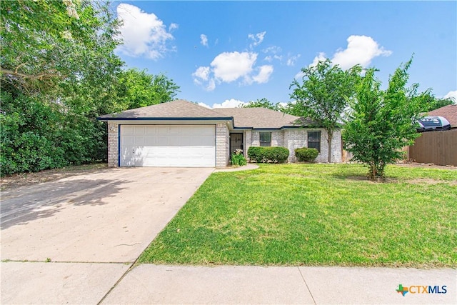 2009 Fleetwood Dr, Killeen, TX 76543 - view of front facade with a garage, brick siding, and concrete driveway