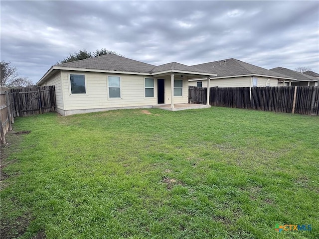 back of property featuring a lawn and a patio