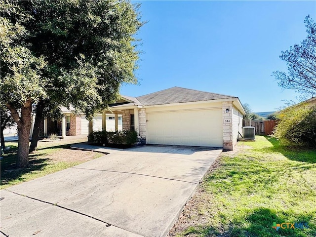 ranch-style home with central AC, a garage, and a front lawn