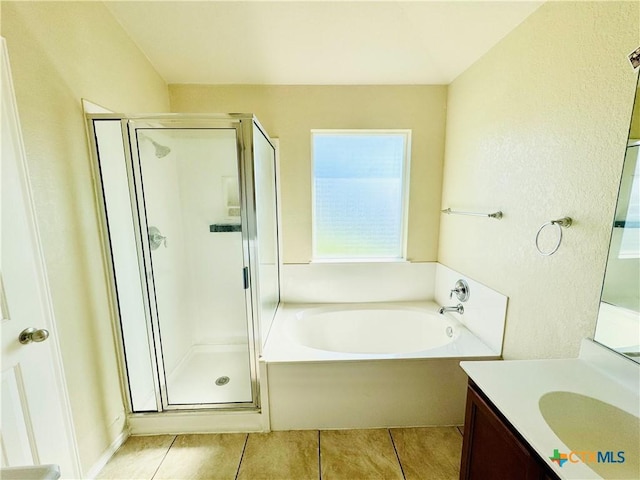 bathroom featuring vanity, shower with separate bathtub, and tile patterned floors