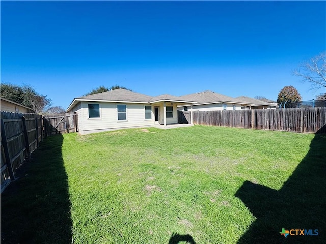 rear view of house featuring a yard