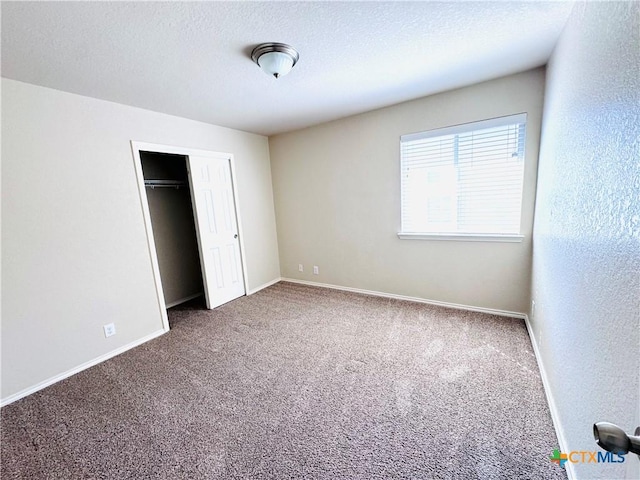 unfurnished bedroom with a closet, a textured ceiling, and carpet flooring