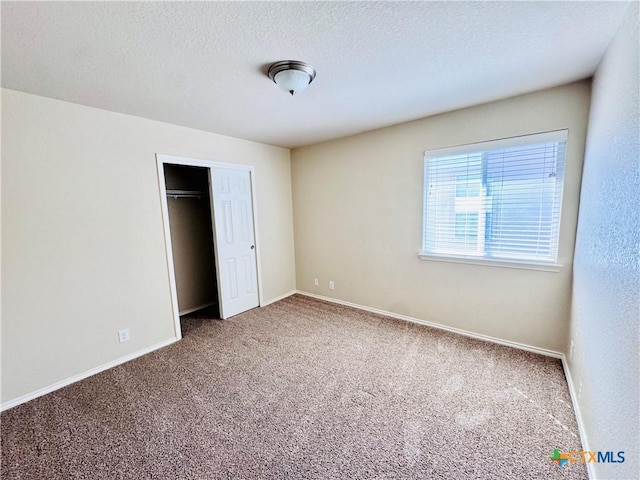 unfurnished bedroom featuring a closet, carpet, and a textured ceiling