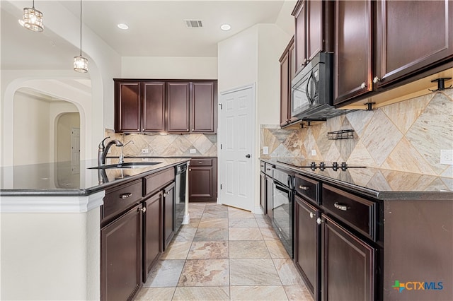 kitchen featuring pendant lighting, sink, backsplash, and black appliances