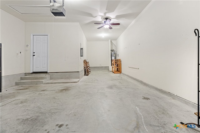 garage featuring electric panel, ceiling fan, water heater, and a garage door opener