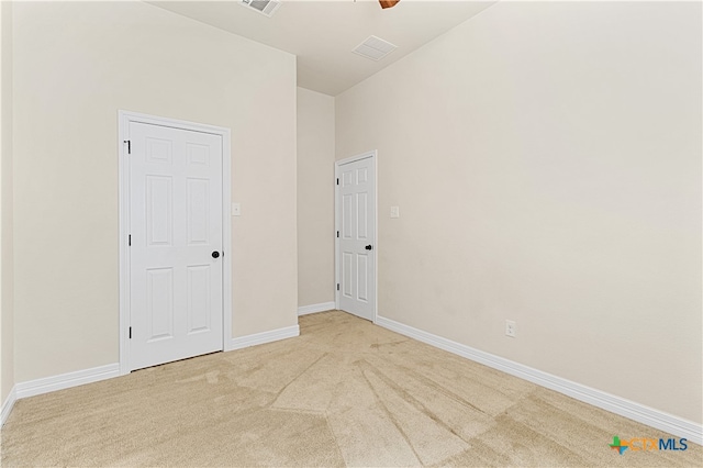 empty room featuring light carpet