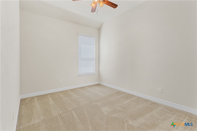 carpeted empty room with ceiling fan and vaulted ceiling