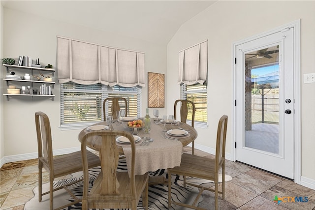 dining room featuring a healthy amount of sunlight and lofted ceiling