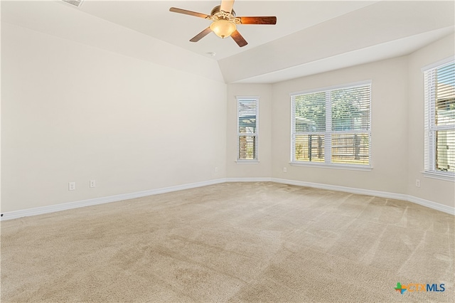 unfurnished room featuring light carpet, vaulted ceiling, and ceiling fan