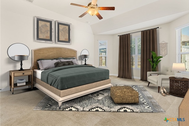 carpeted bedroom with vaulted ceiling and ceiling fan