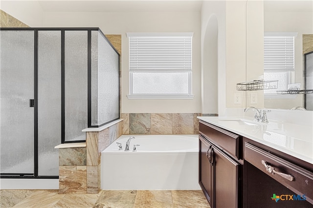 bathroom featuring shower with separate bathtub and vanity