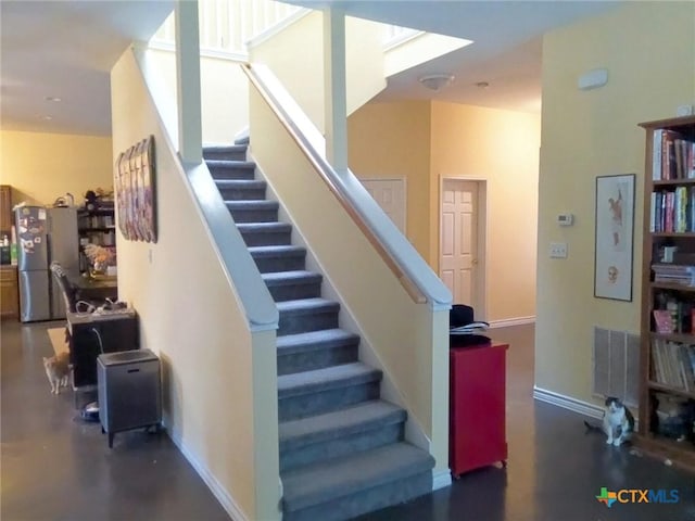 618 Pecos St, Lockhart, TX 78644 - staircase with baseboards and a skylight