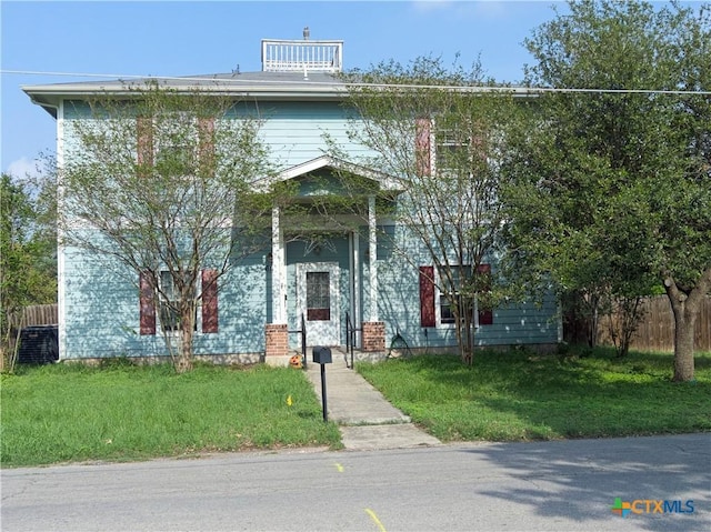 618 Pecos St, Lockhart, TX 78644 - view of front of property featuring a front lawn and fence